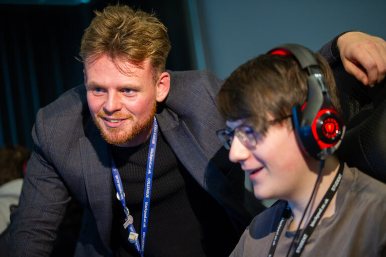 Student and tutor looking at esport screen